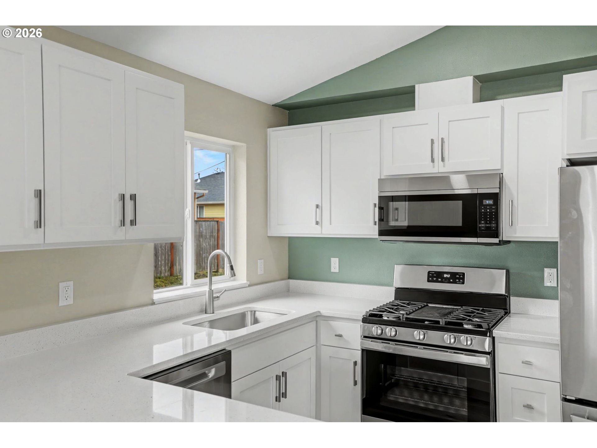 7425 5th Street Southeast Turner, OR 97392 - Photo 12 of 47 a kitchen with stainless steel appliances a sink stove and cabinets