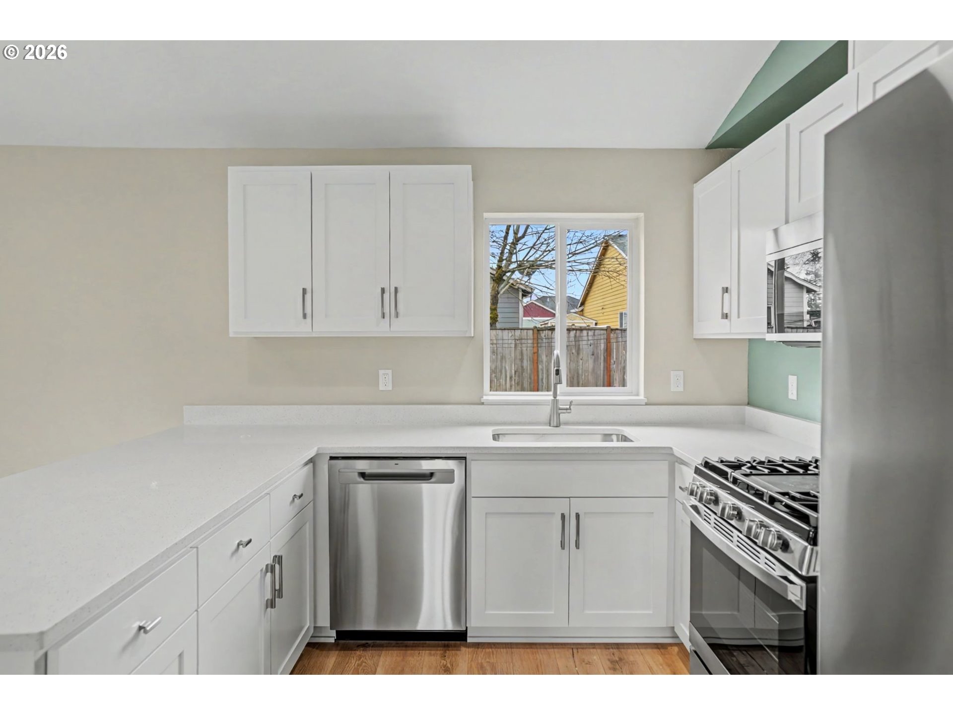 7425 5th Street Southeast Turner, OR 97392 - Photo 13 of 47 a kitchen with white cabinets and sink