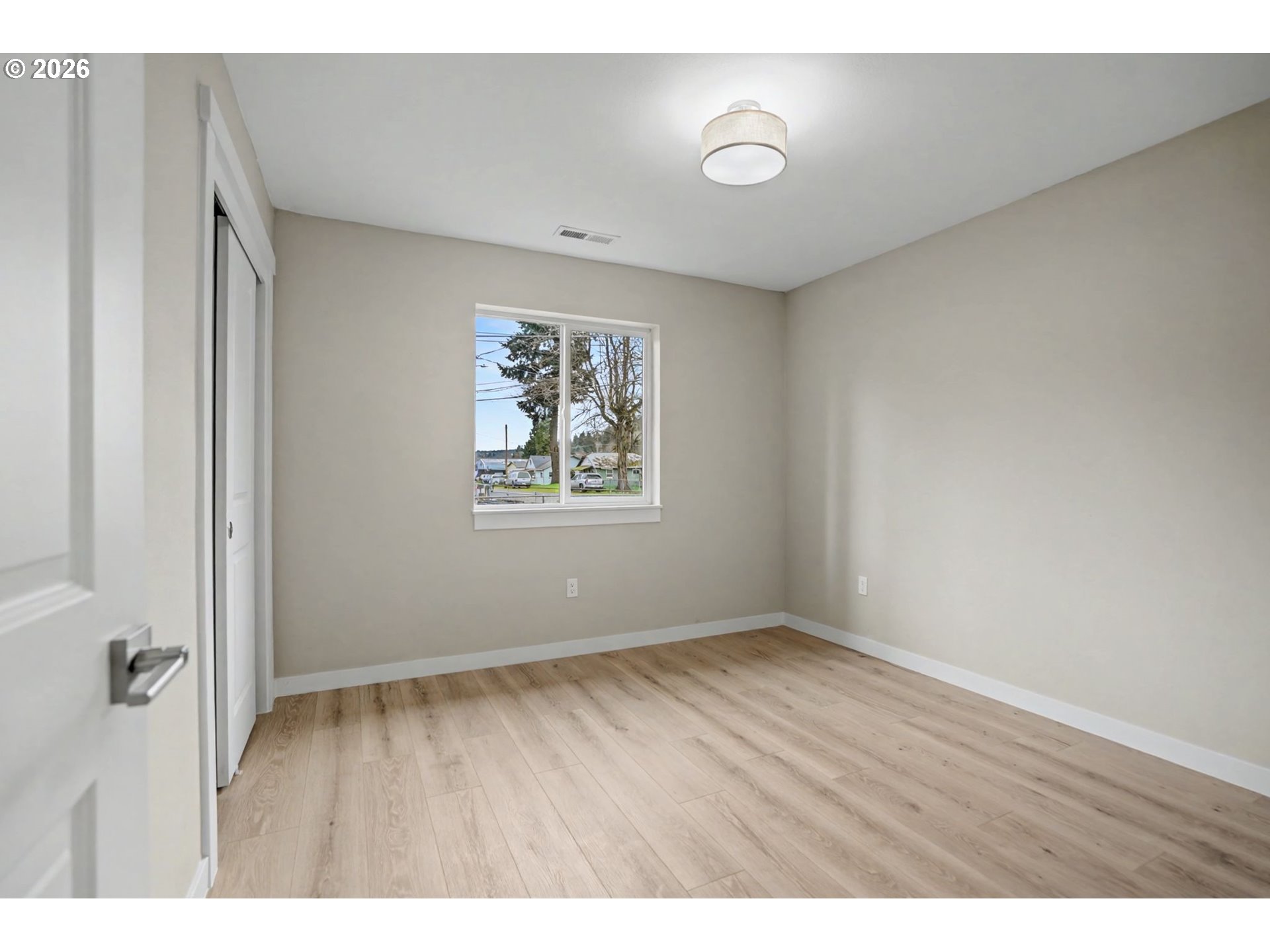 7425 5th Street Southeast Turner, OR 97392 - Photo 17 of 47 a view of an empty room with wooden floor and a window