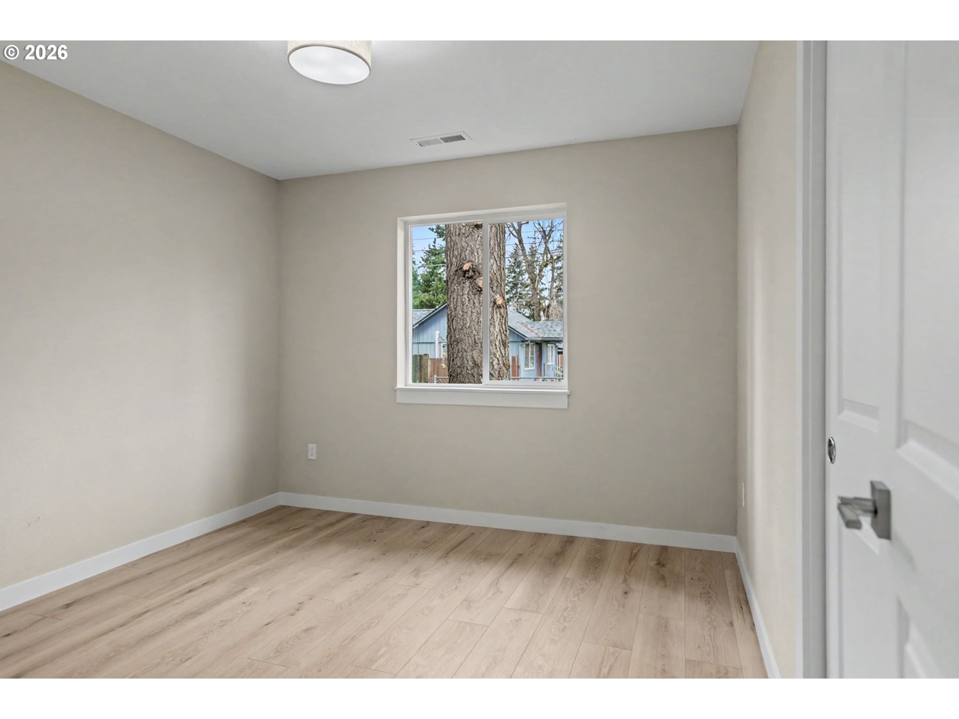 7425 5th Street Southeast Turner, OR 97392 - Photo 20 of 47 a view of an empty room with wooden floor and a window