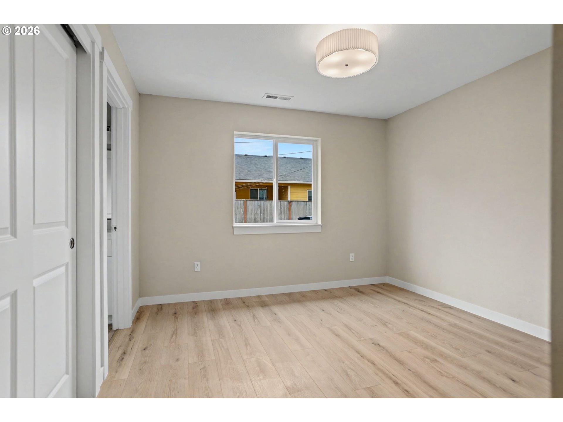 7425 5th Street Southeast Turner, OR 97392 - Photo 22 of 47 a view of an empty room with wooden floor and a window