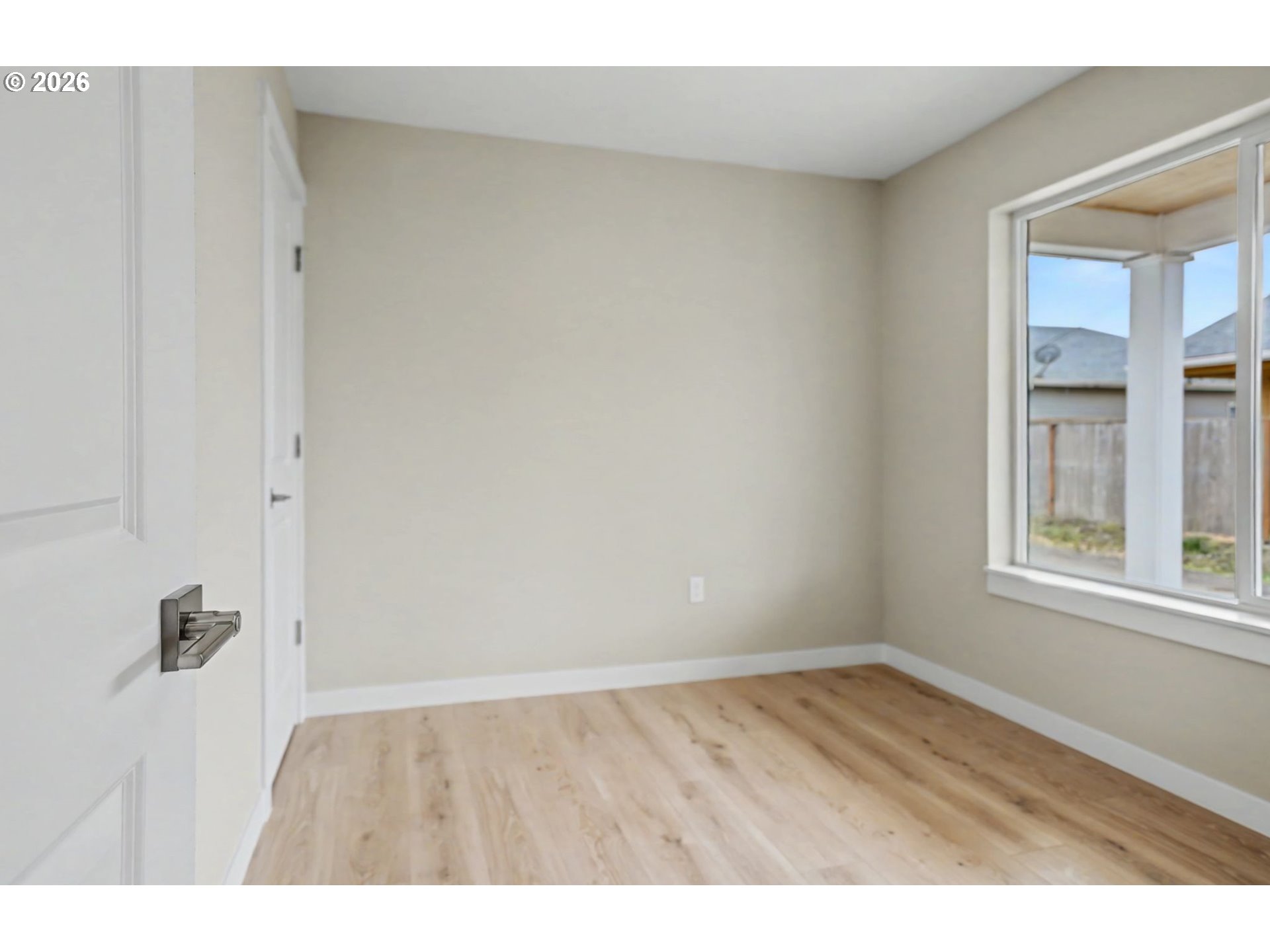 7425 5th Street Southeast Turner, OR 97392 - Photo 27 of 47 a view of an empty room with wooden floor and a window