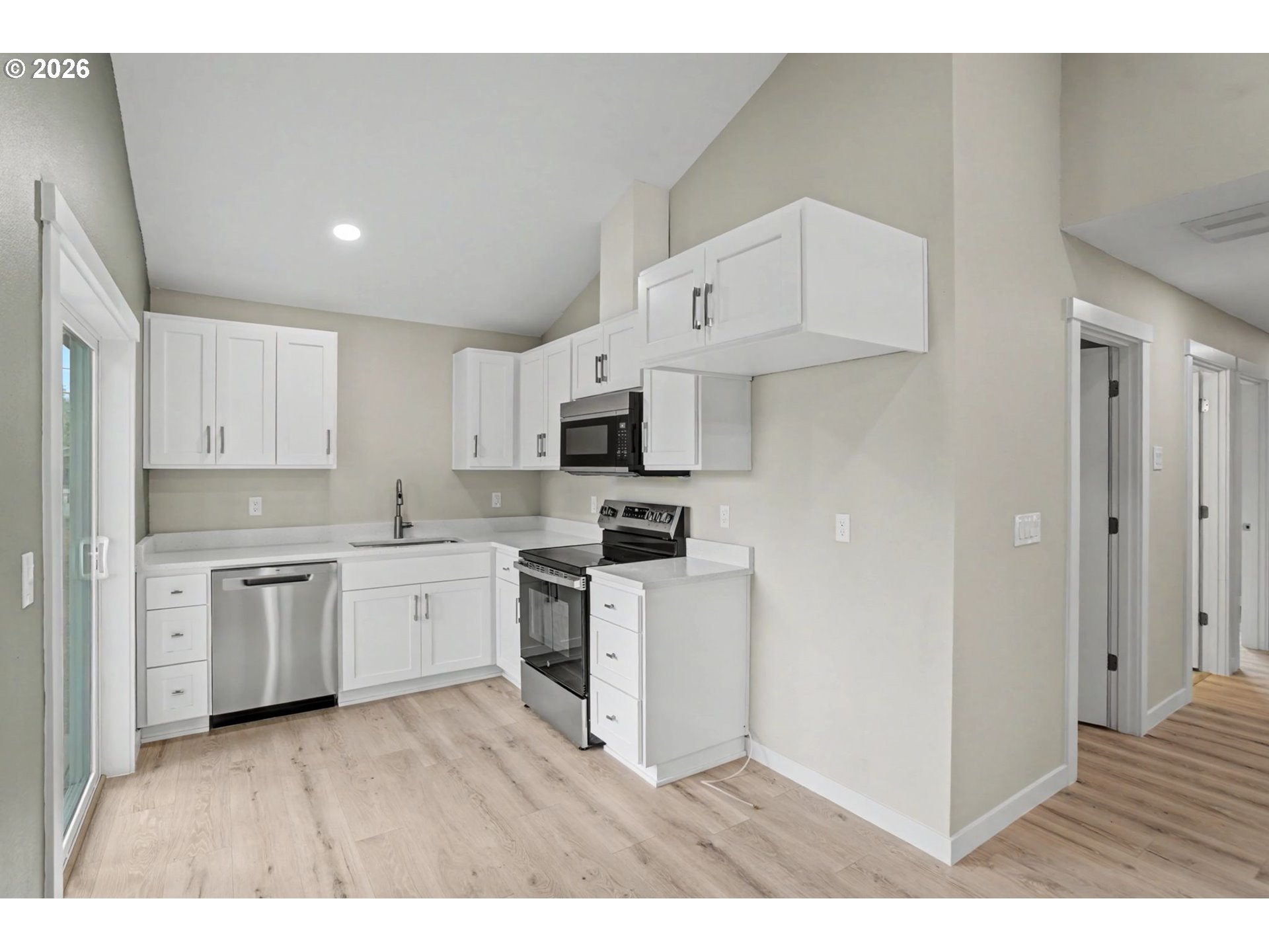 7425 5th Street Southeast Turner, OR 97392 - Photo 44 of 47 a kitchen with granite countertop a sink a stove a refrigerator and white cabinets