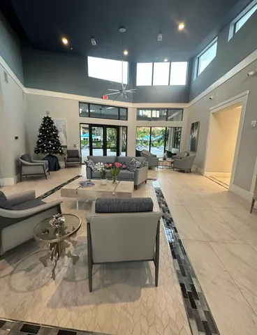 a living room with furniture a large window and a table