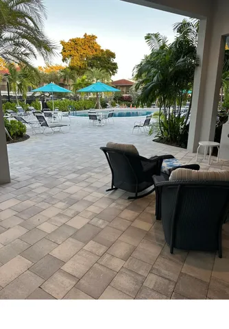 a swimming pool with outdoor seating and yard