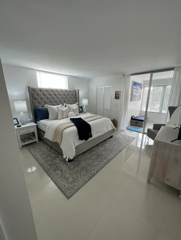 a bedroom with a large bed and a couch