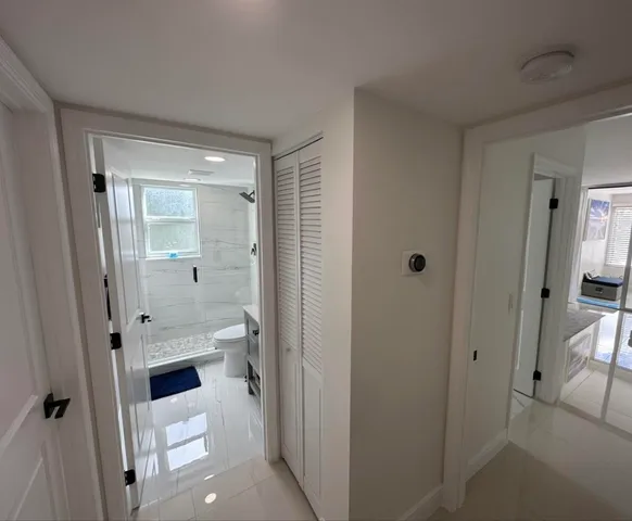 a bathroom with a double vanity sink toilet and shower