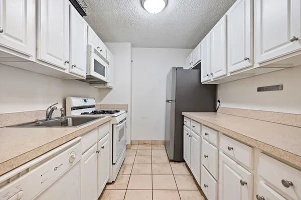 a kitchen with granite countertop a sink and cabinets