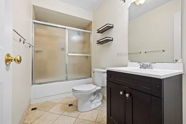 a bathroom with a sink toilet and shower