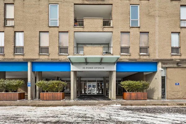 a front view of a building with a garden