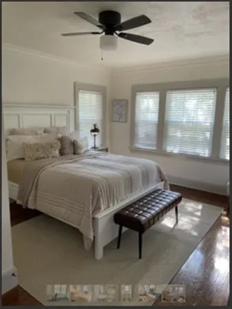 a bedroom with a bed and window
