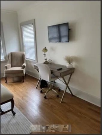 a workspace with furniture and wooden floor