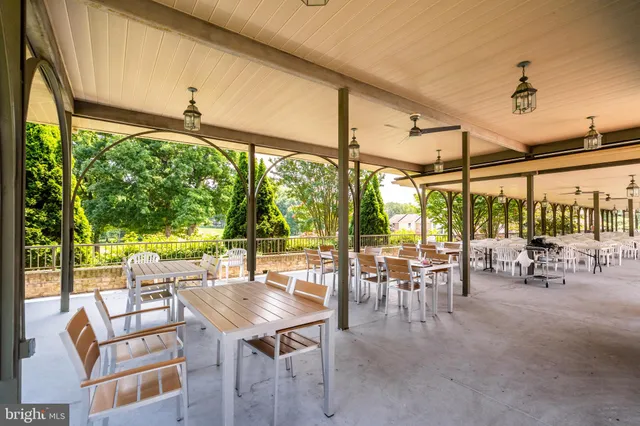 a view of a patio with table and chairs