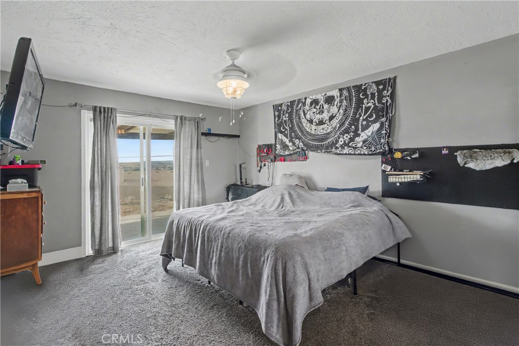 14798 Keota Road Apple Valley, CA 92307 - Photo 11 of 27 a bedroom with a bed and a window