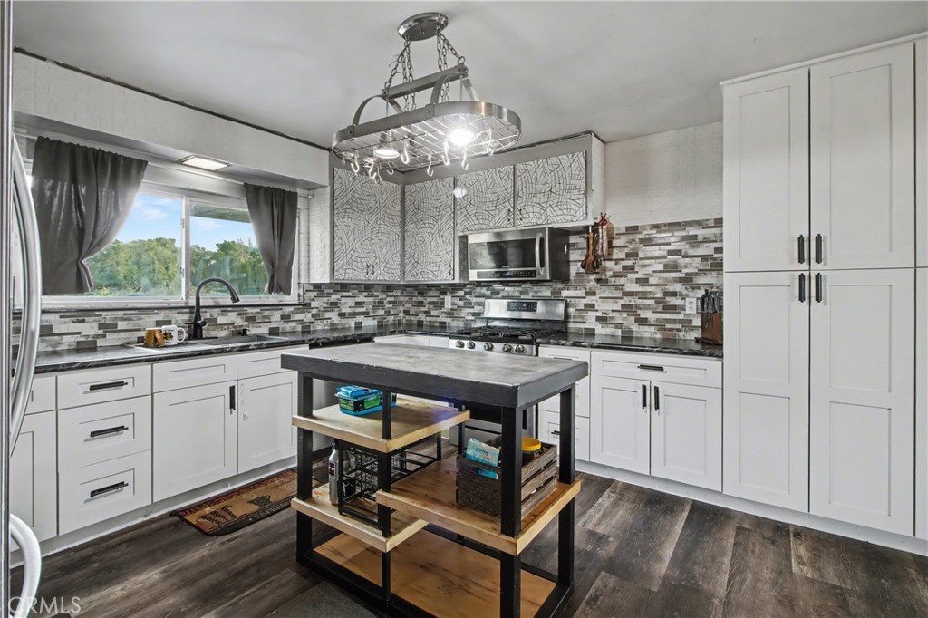 14798 Keota Road Apple Valley, CA 92307 - Photo 6 of 27 a kitchen with stainless steel appliances granite countertop a stove a sink and a refrigerator