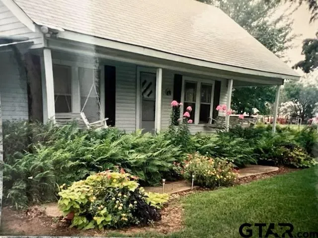 front view of the house with a yard