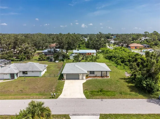 an aerial view of a house with a yard