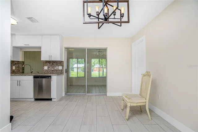 a kitchen with white cabinets and sink