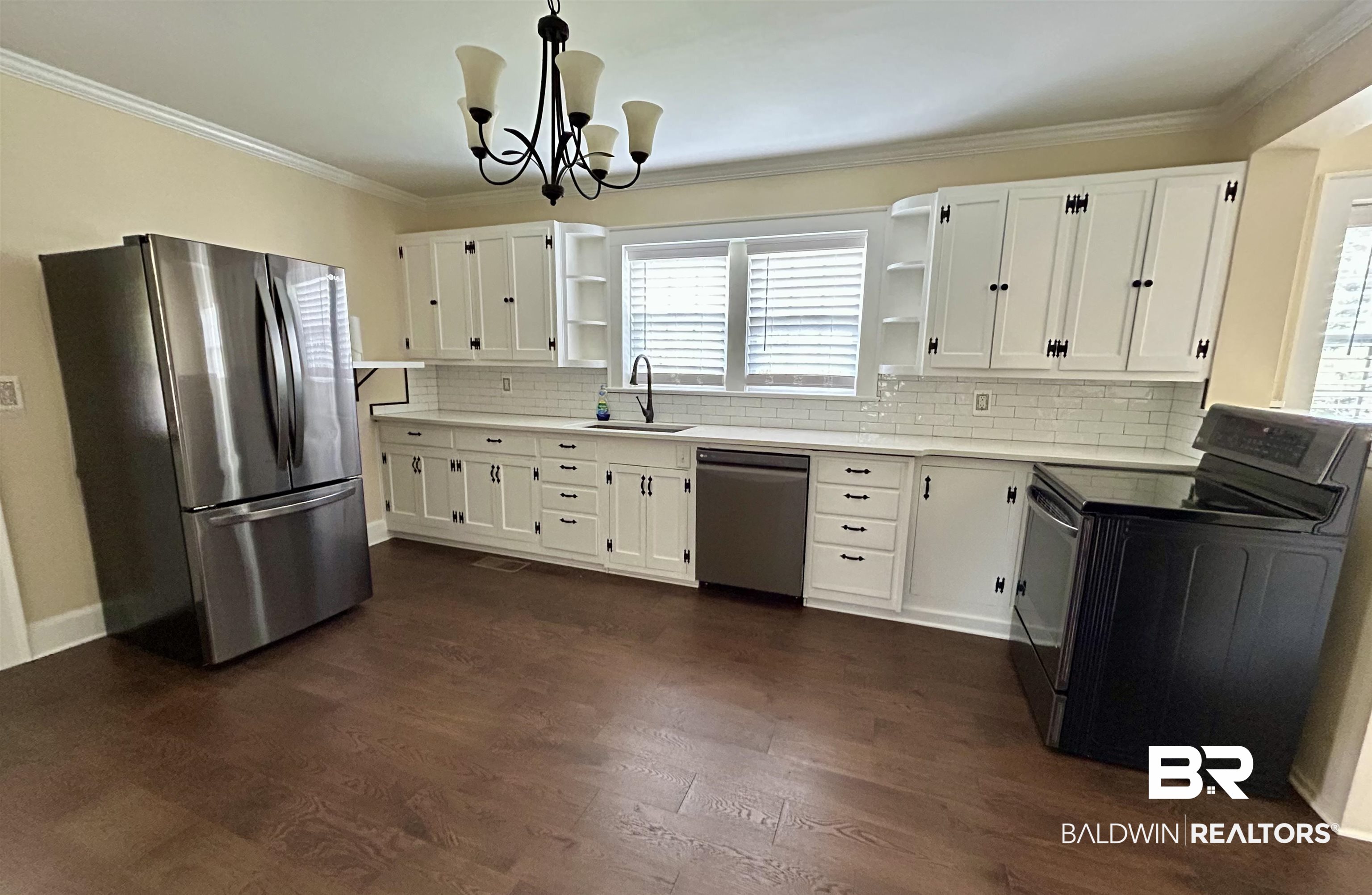 1405 Escambia Avenue Brewton, AL 36426 - Photo 6 of 16 Kitchen featuring open shelves, appliances with stainless steel finishes, decorative backsplash, crown molding, and white cabinets