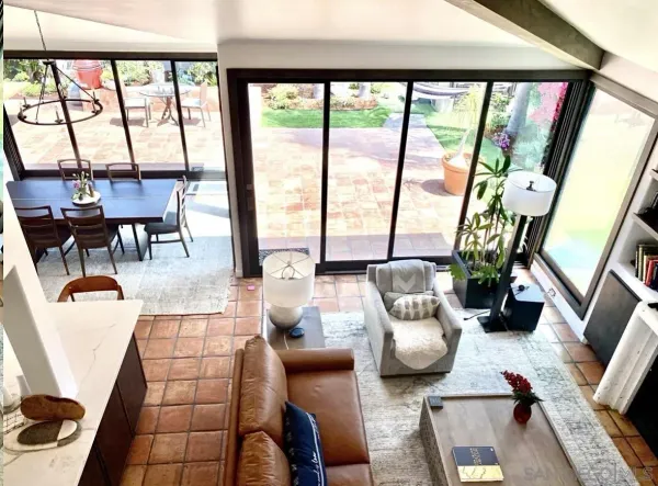 a living room with furniture and a floor to ceiling window