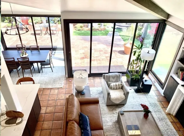 a living room with furniture and a floor to ceiling window