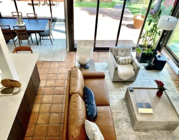a living room with furniture and a floor to ceiling window