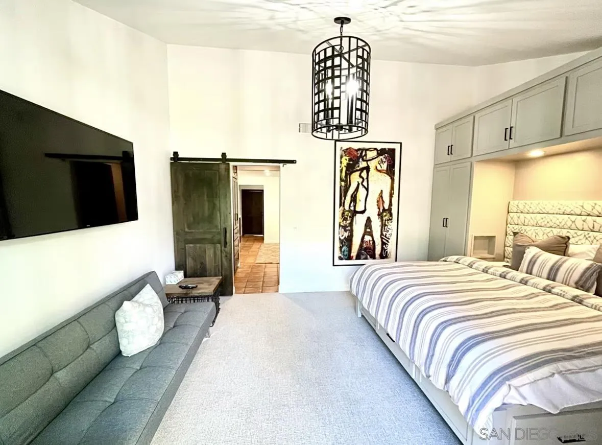 216 21st Street Del Mar, CA 92014 - Photo 21 of 31 a bedroom with a bed and flat screen tv
