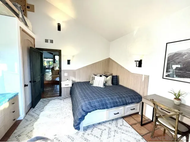 a living room with a couch and dresser