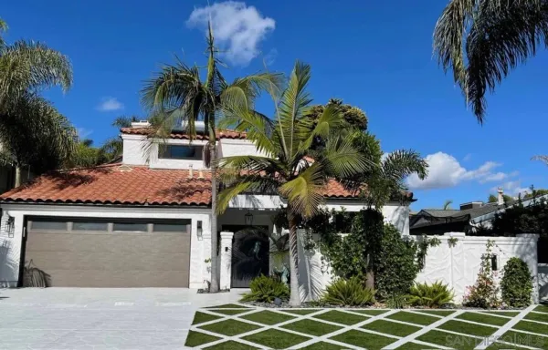 an aerial view of residential houses with outdoor space and ocean view