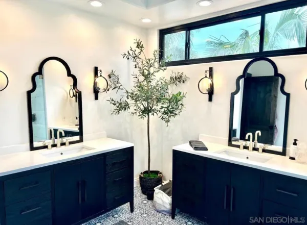 a bathroom with a double vanity sink and a mirror