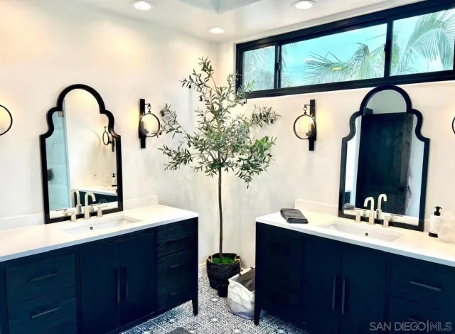 a bathroom with a double vanity sink and a mirror