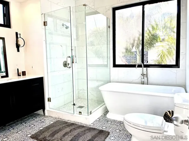 a bathroom with a shower a toilet and a sink