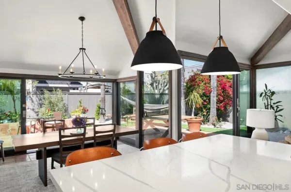 a living room with furniture and floor to ceiling windows