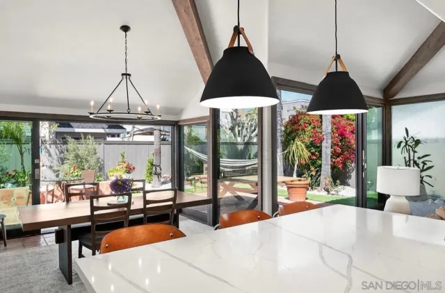 a living room with furniture and floor to ceiling windows