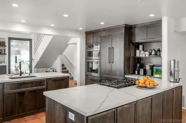 a kitchen with stainless steel appliances a sink and stove