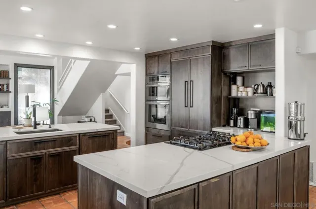 a kitchen with stainless steel appliances a sink and stove