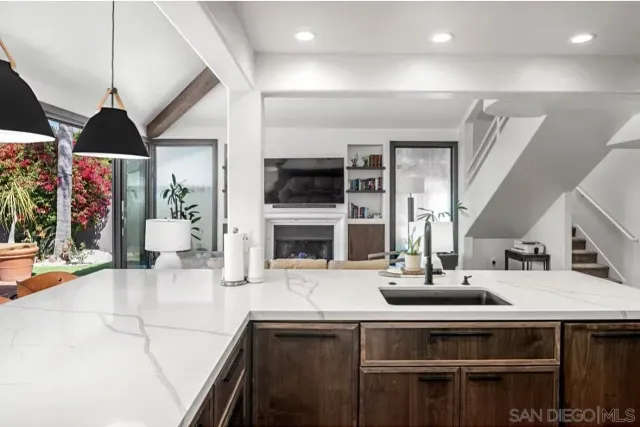 a kitchen with stainless steel appliances a sink and a stove