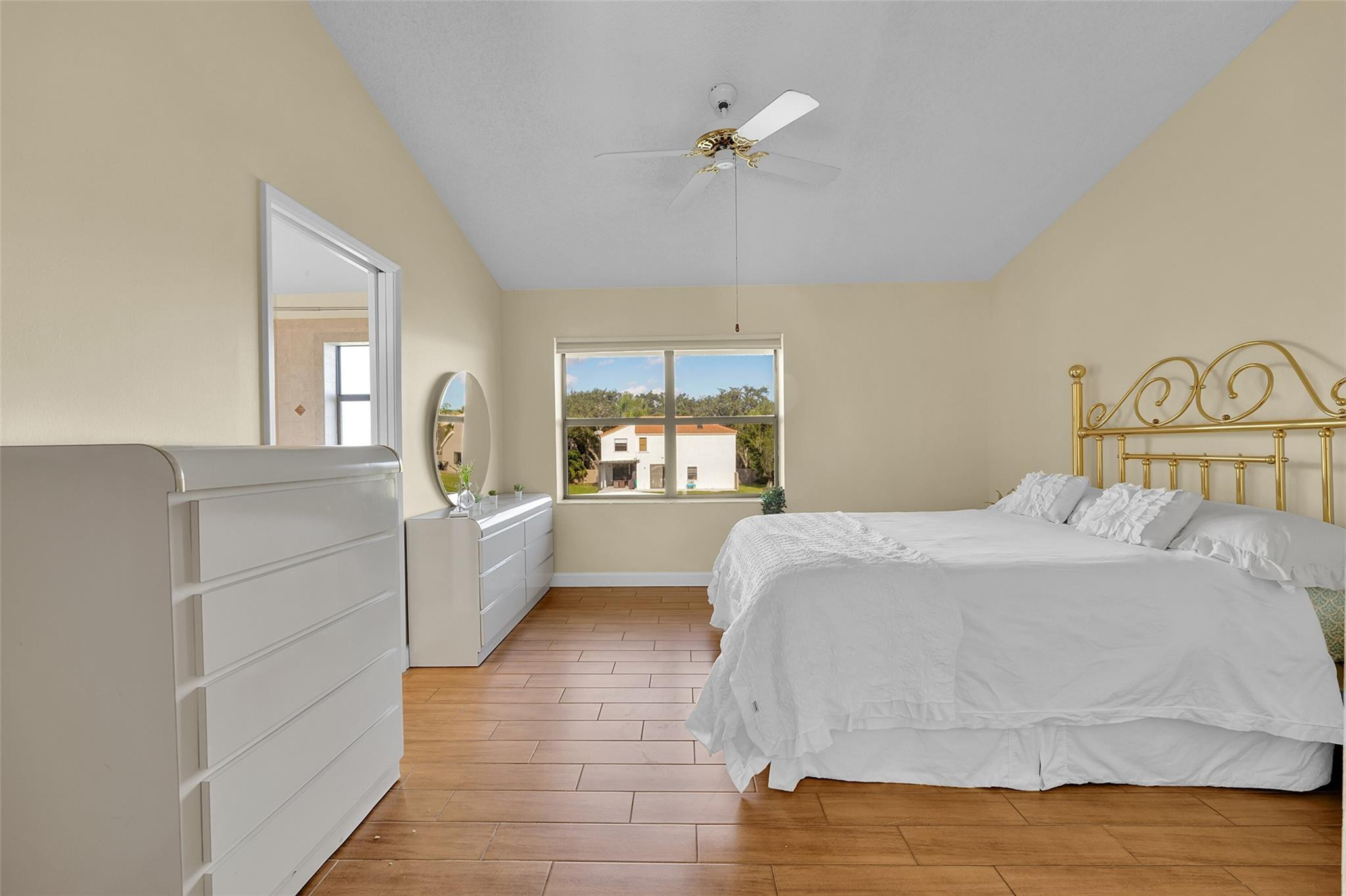 10761 Northwest 14th Street, Unit 281 Plantation, FL 33322 - Photo 20 of 33 a bedroom with a large bed and a chandelier