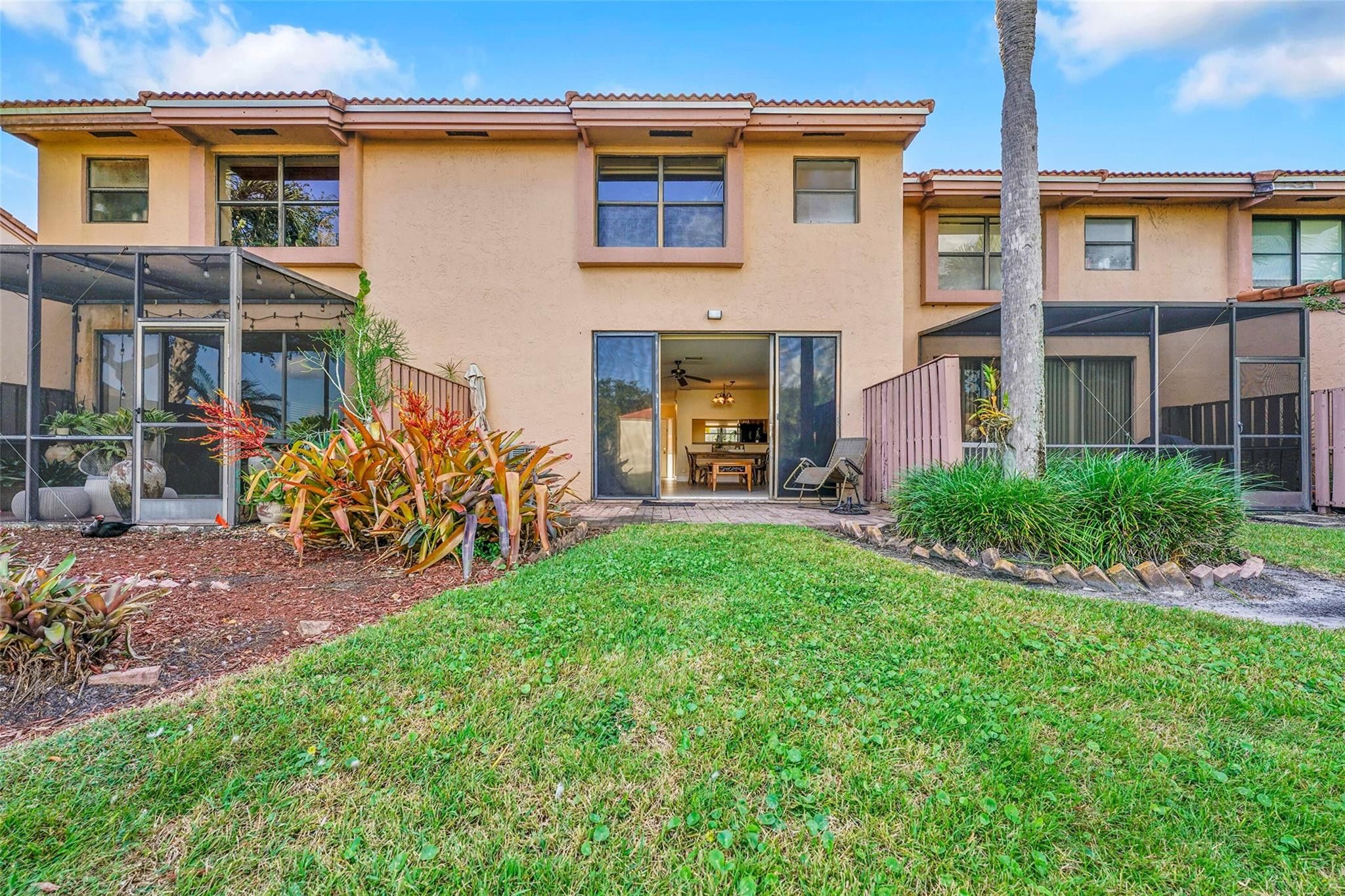 10761 Northwest 14th Street, Unit 281 Plantation, FL 33322 - Photo 27 of 33 a view of a house with brick walls and a yard with plants