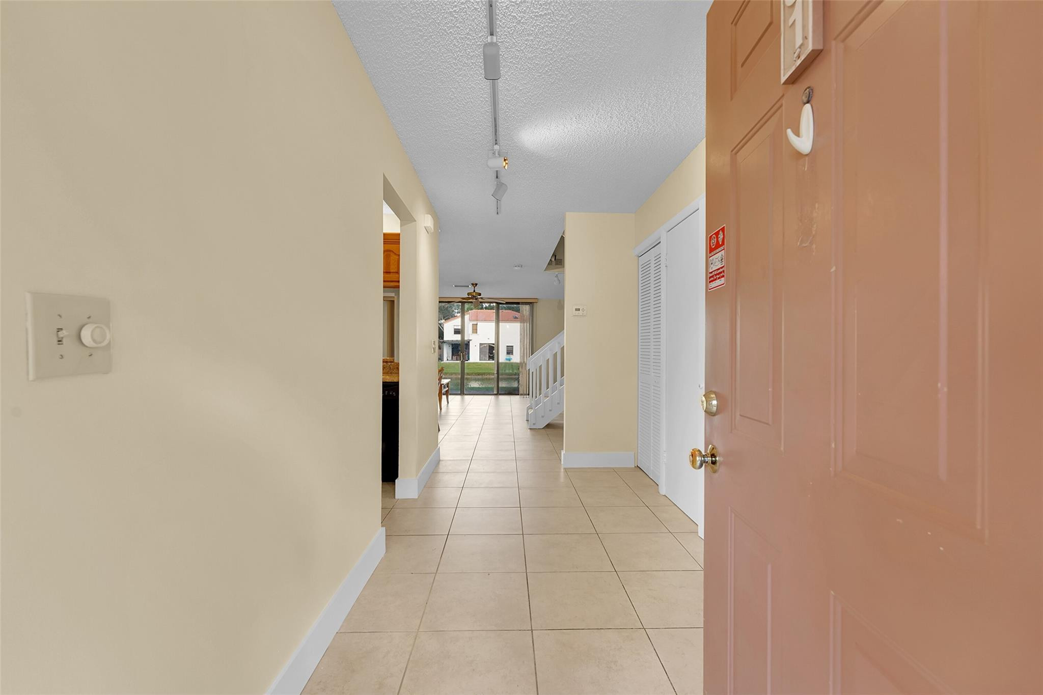 10761 Northwest 14th Street, Unit 281 Plantation, FL 33322 - Photo 3 of 33 a view of a hallway with a dining table and chairs
