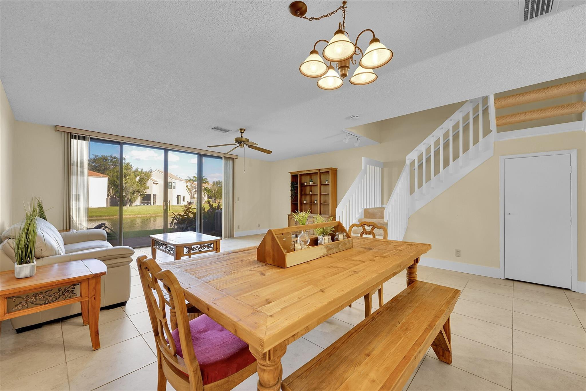 10761 Northwest 14th Street, Unit 281 Plantation, FL 33322 - Photo 9 of 33 a view of a dining room with furniture a chandelier and large windows