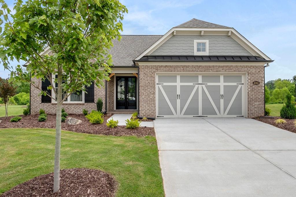 4060 Raeburn Road Cumming, GA 30028 - Photo 1 of 1 a front view of a house with garden
