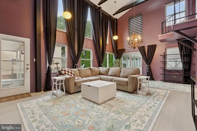 a living room with furniture a window and a flat screen tv