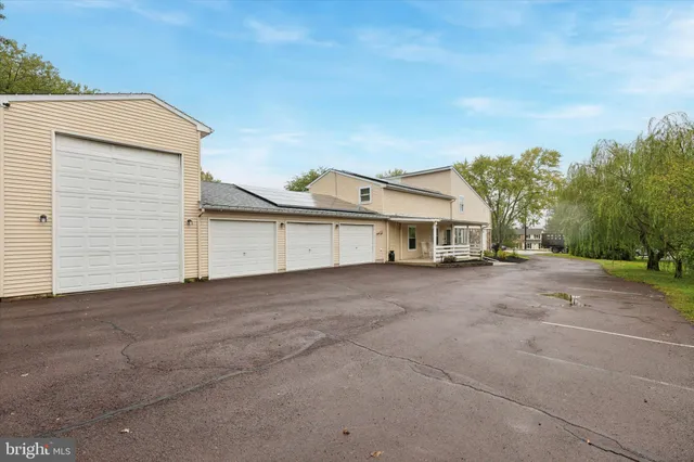 a view of a house with a yard and garage