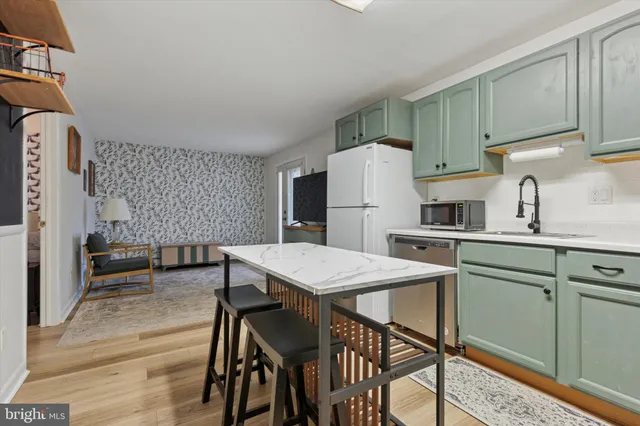a kitchen with a table chairs refrigerator and cabinets