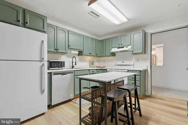 a kitchen with a refrigerator a stove a sink and a refrigerator