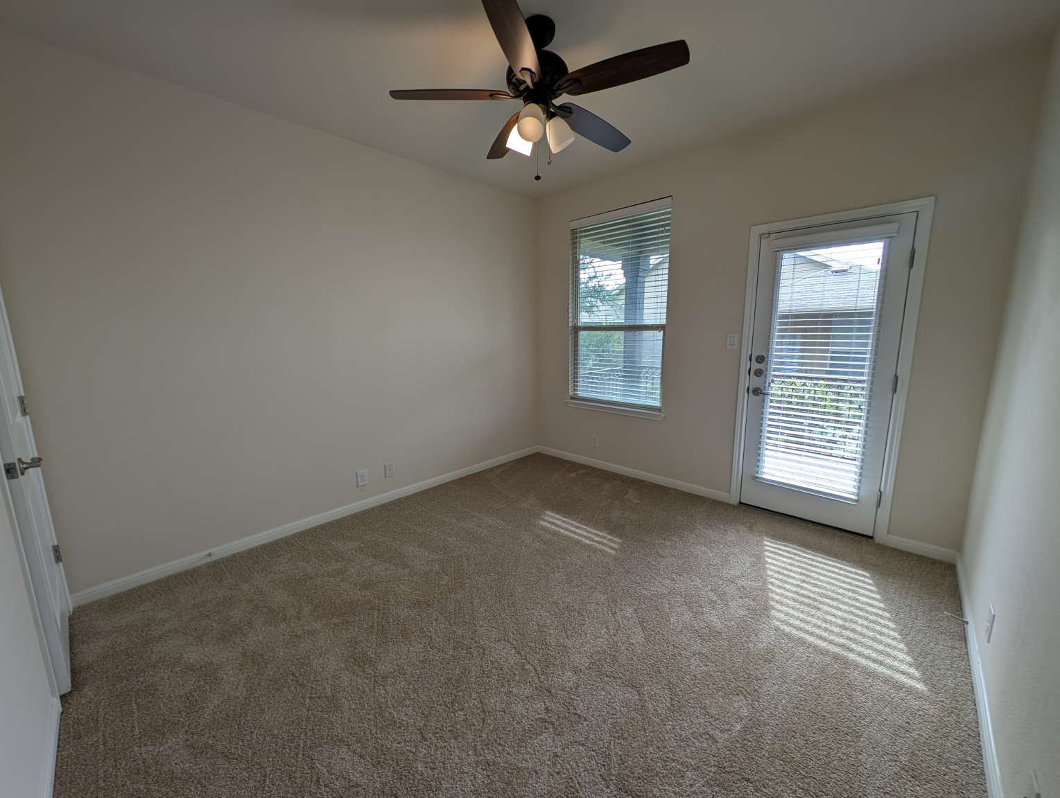 7301 Bandera Ranch Trail, Unit A Austin, TX 78750 - Photo 14 of 20 A spacious bedroom features a private outdoor entrance and a broad window.