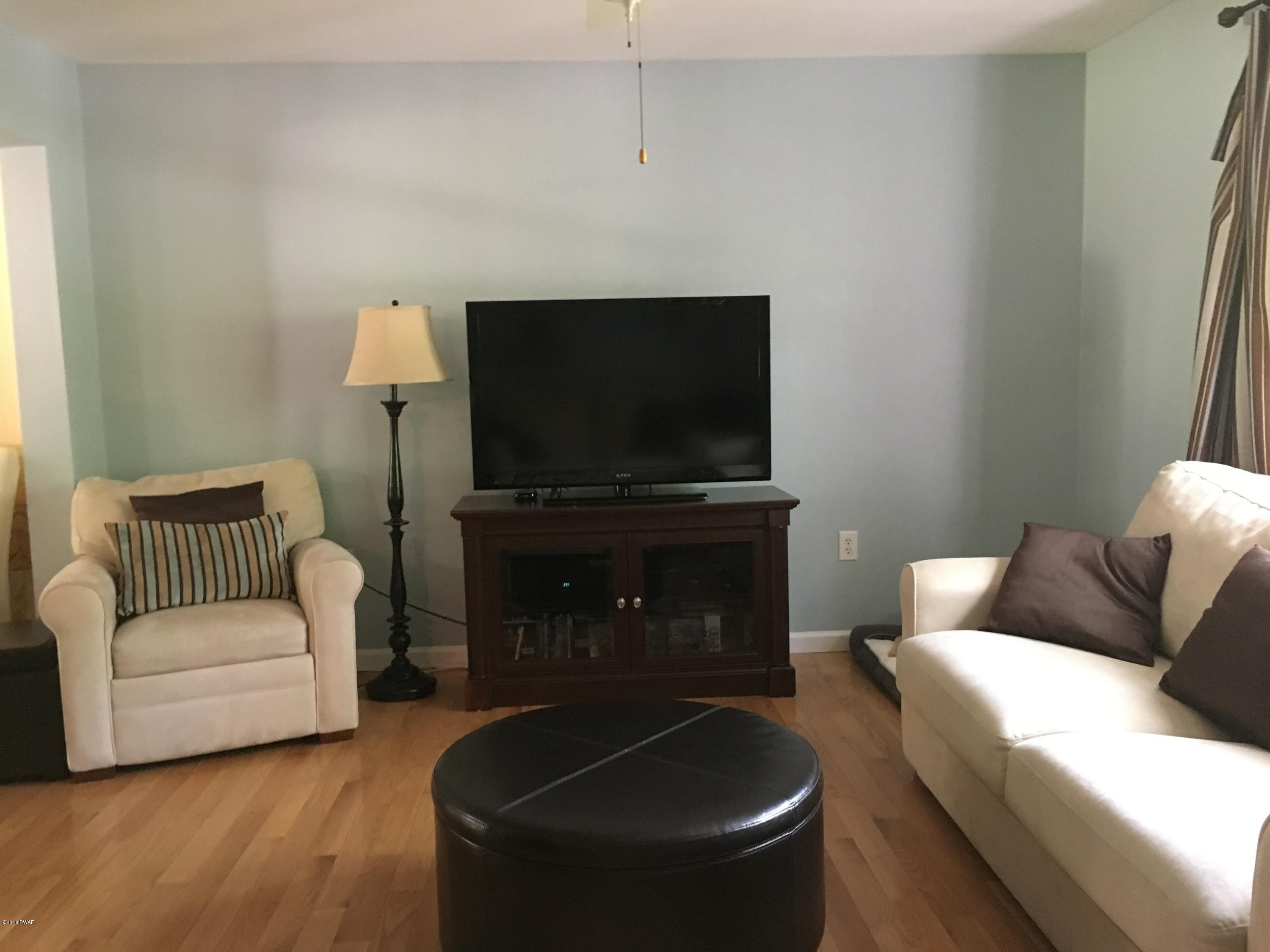 154 Butternut Road Milford, PA 18337 - Photo 3 of 14 a living room with furniture and a flat screen tv