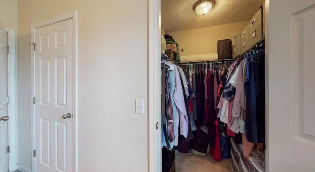 a view of walk in closet with clothes