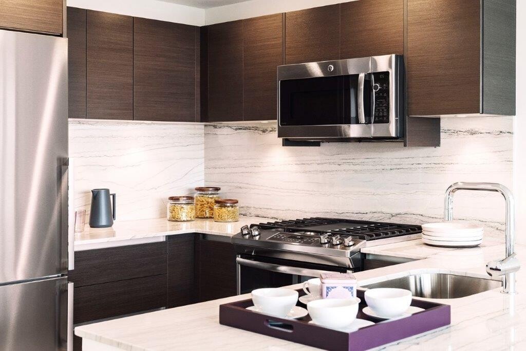 315 West 33rd Street, Unit 12B Manhattan, NY 10001 - Photo 1 of 14 a kitchen with a stove and a microwave